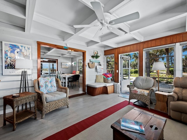 living room featuring beamed ceiling, light wood-type flooring, ceiling fan, and coffered ceiling