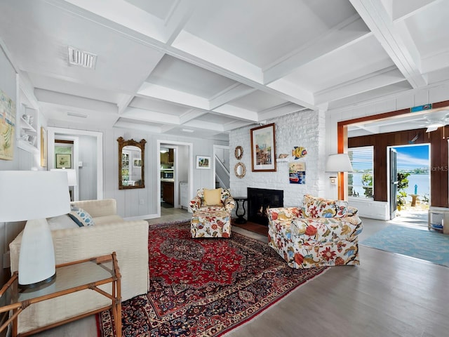 living room with beam ceiling, a fireplace, hardwood / wood-style floors, and coffered ceiling