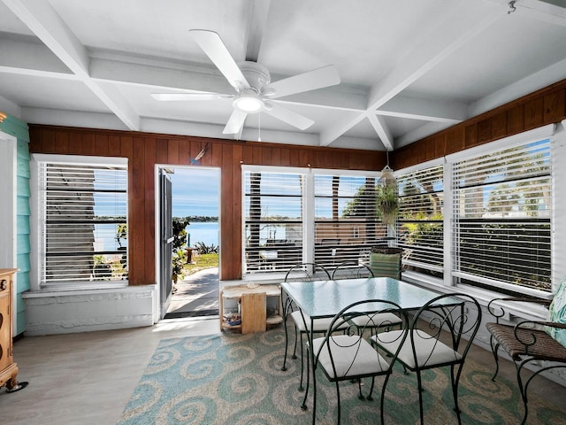 sunroom / solarium featuring beamed ceiling, a water view, ceiling fan, and coffered ceiling