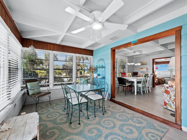 sunroom with beamed ceiling and ceiling fan