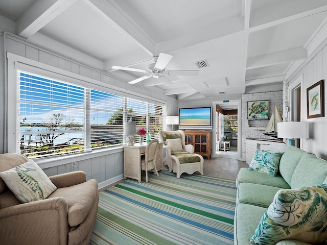 sunroom with beamed ceiling and ceiling fan