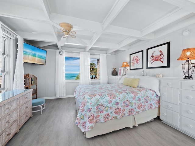 bedroom with beam ceiling, light wood-type flooring, ceiling fan, and coffered ceiling