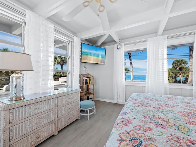 bedroom featuring hardwood / wood-style floors, ceiling fan, beamed ceiling, and coffered ceiling