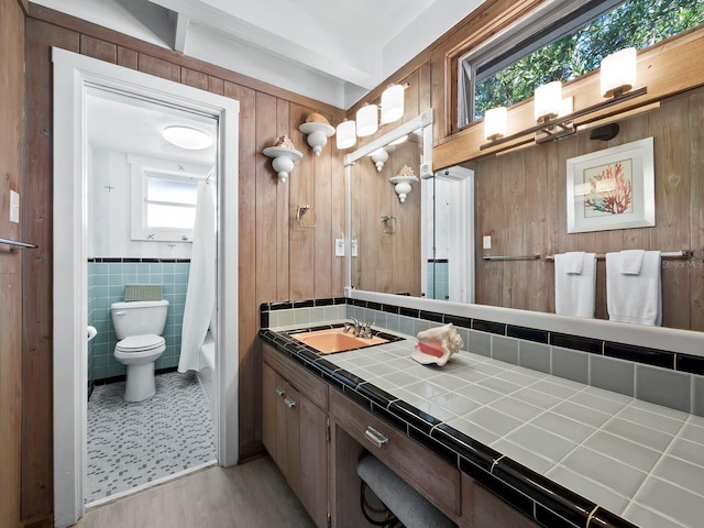 1620 Casey Key Rd, Nokomis, FL 34275 - full bathroom featuring vanity, shower / tub combo, tile walls, wood finished floors, and wooden walls