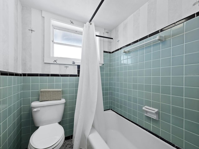 bathroom with shower / tub combo, tile walls, and toilet