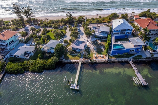 birds eye view of property with a view of the beach and a water view