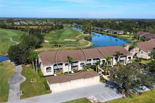 drone / aerial view with a residential view, view of golf course, and a water view