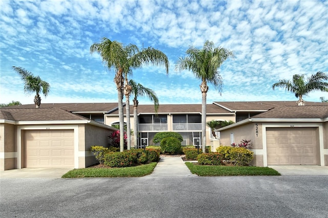 view of front of property with an attached garage, concrete driveway, and stucco siding