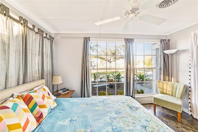 bedroom with multiple windows, ceiling fan, and visible vents