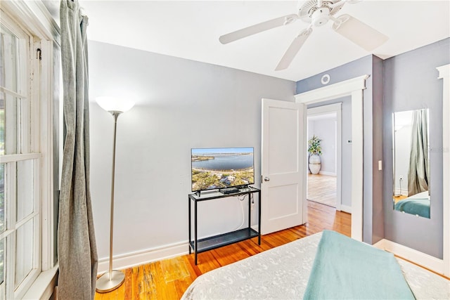 bedroom with ceiling fan and wood-type flooring