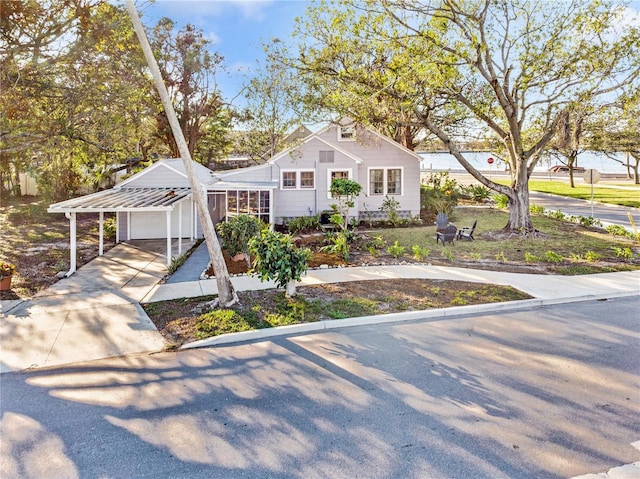 bungalow featuring a garage and a carport