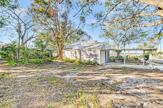 view of front of home with driveway and an outbuilding