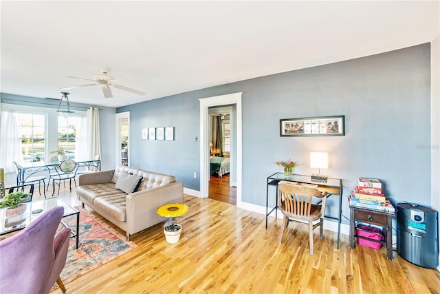 living room featuring ceiling fan and light wood-type flooring