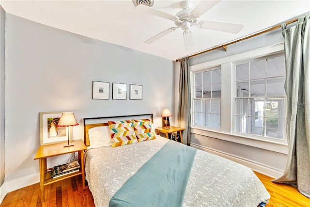 bedroom with ceiling fan and hardwood / wood-style floors