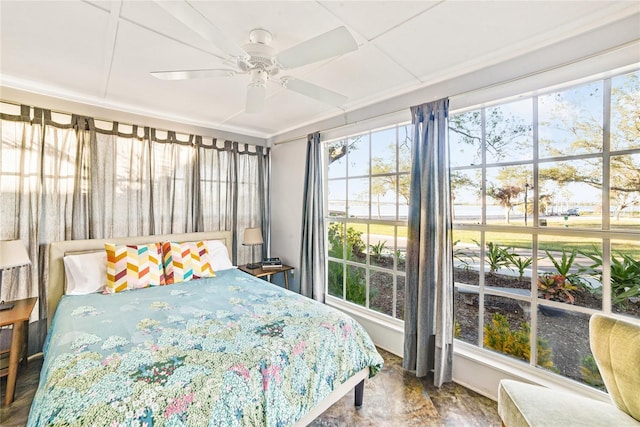 bedroom featuring a ceiling fan and multiple windows