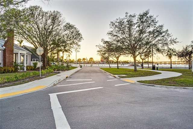 view of street with traffic signs, curbs, and sidewalks