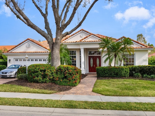 mediterranean / spanish-style home featuring a front yard