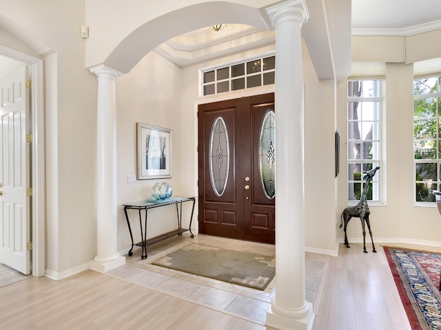 entryway featuring hardwood / wood-style floors, plenty of natural light, and crown molding