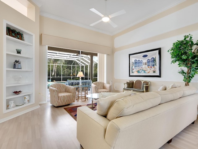 living room featuring ceiling fan, built in features, ornamental molding, and light hardwood / wood-style flooring