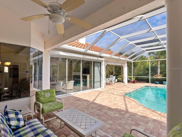 view of pool featuring a lanai, ceiling fan, a patio area, and an outdoor hangout area