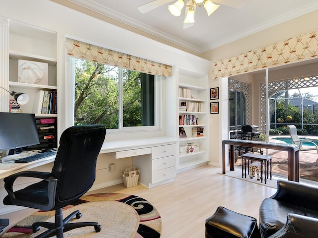 home office featuring ceiling fan, built in features, ornamental molding, and light hardwood / wood-style flooring