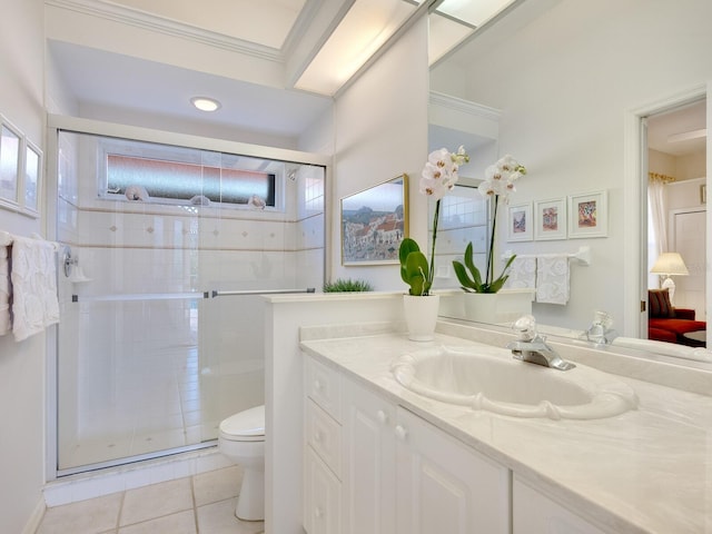 bathroom featuring tile patterned floors, vanity, toilet, and a shower with door