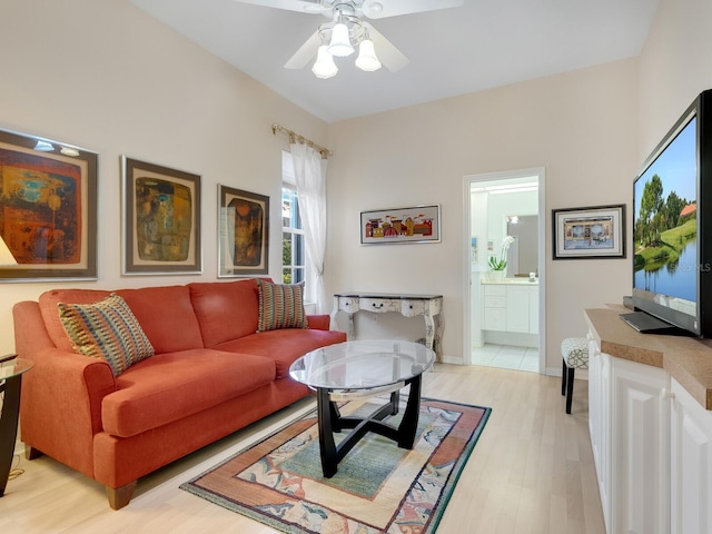 living room with light wood-type flooring and ceiling fan