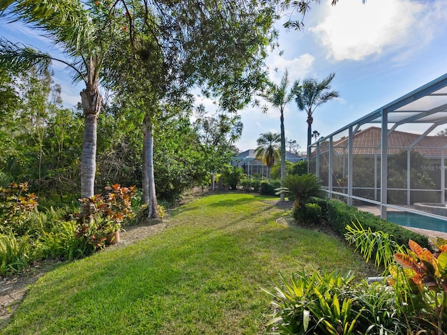 view of yard with glass enclosure