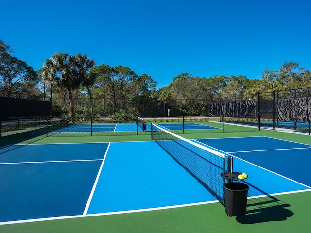 view of tennis court featuring basketball hoop