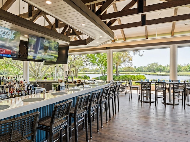 exterior space featuring a water view and a bar