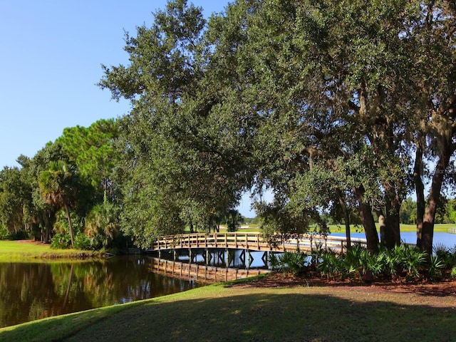 dock area featuring a lawn and a water view