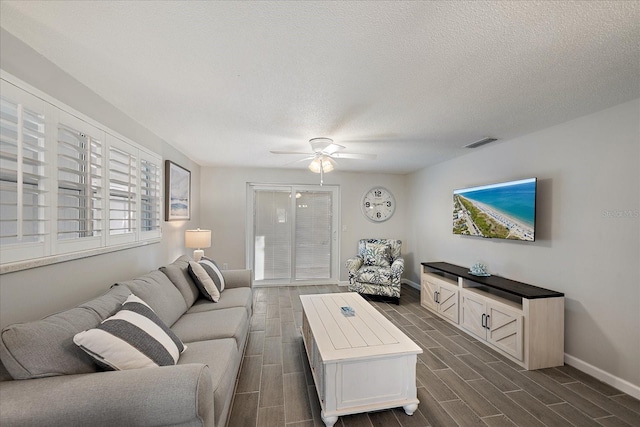 1123 Crescent St Unit 1123/1125, Sarasota, FL 34242 - living room featuring baseboards, a ceiling fan, wood tiled floors, and a textured ceiling