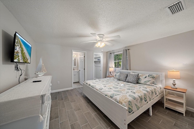 1123 Crescent St Unit 1123/1125, Sarasota, FL 34242 - bedroom with wood finish floors, baseboards, a textured ceiling, ceiling fan, and ensuite bath