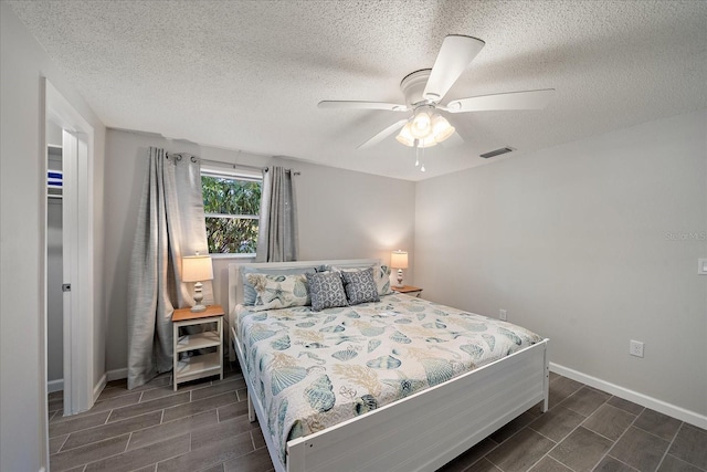 1123 Crescent St Unit 1123/1125, Sarasota, FL 34242 - bedroom featuring wood finish floors, a textured ceiling, baseboards, and a ceiling fan