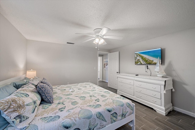 1123 Crescent St Unit 1123/1125, Sarasota, FL 34242 - bedroom with baseboards, dark wood-type flooring, a ceiling fan, and a textured ceiling