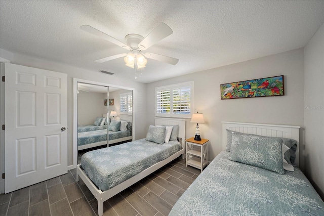 1123 Crescent St Unit 1123/1125, Sarasota, FL 34242 - bedroom with a closet, wood finish floors, a textured ceiling, ceiling fan, and baseboards