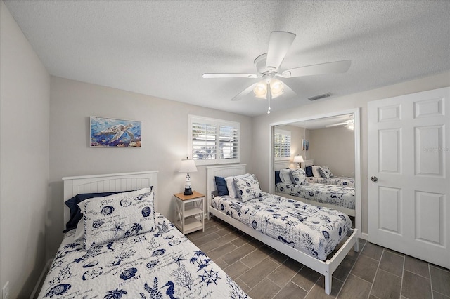 1123 Crescent St Unit 1123/1125, Sarasota, FL 34242 - bedroom featuring a textured ceiling, wood finish floors, a ceiling fan, and baseboards