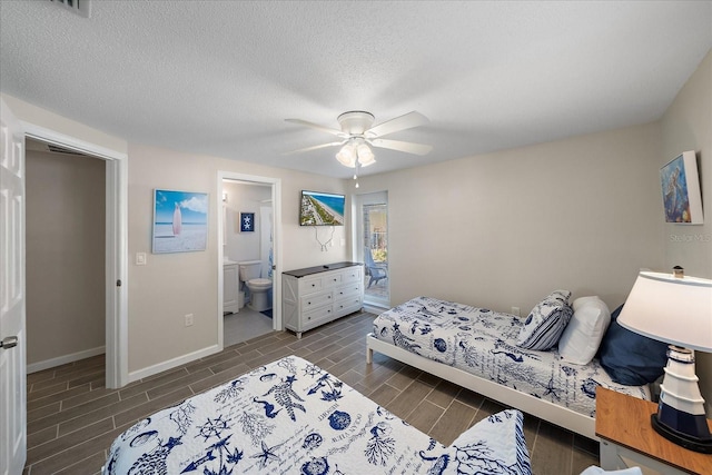 1123 Crescent St Unit 1123/1125, Sarasota, FL 34242 - bedroom featuring connected bathroom, baseboards, ceiling fan, wood tiled floors, and a textured ceiling