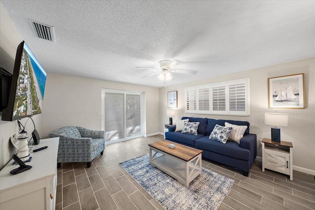 1123 Crescent St Unit 1123/1125, Sarasota, FL 34242 - living room featuring ceiling fan, wood finish floors, baseboards, plenty of natural light, and a textured ceiling