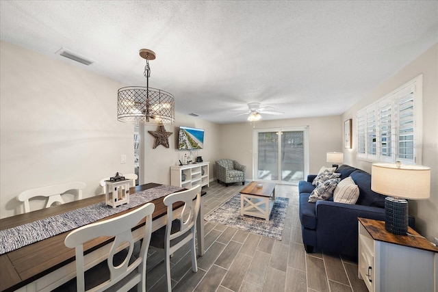 1123 Crescent St Unit 1123/1125, Sarasota, FL 34242 - living area with a textured ceiling, a ceiling fan, and dark wood-style floors