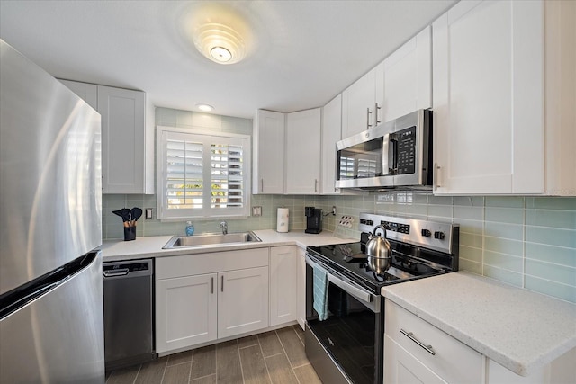 1123 Crescent St Unit 1123/1125, Sarasota, FL 34242 - kitchen with appliances with stainless steel finishes, a sink, decorative backsplash, and light countertops