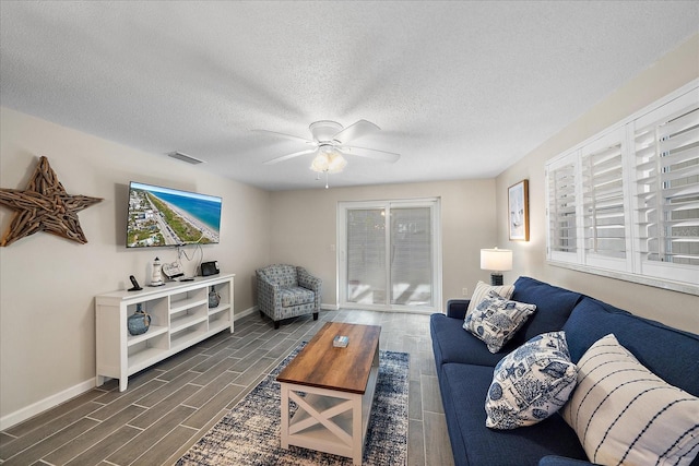 1123 Crescent St Unit 1123/1125, Sarasota, FL 34242 - living room with wood finish floors, baseboards, a ceiling fan, and a textured ceiling