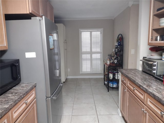 kitchen featuring light tile patterned flooring, ornamental molding, and dark stone counters