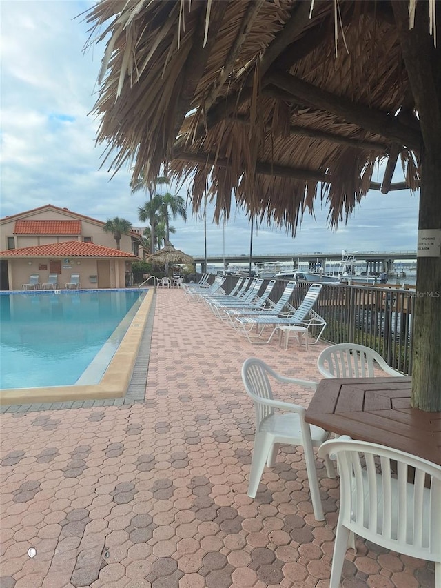 view of swimming pool with a water view