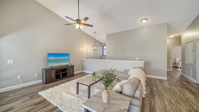 living room with ceiling fan, high vaulted ceiling, and hardwood / wood-style floors