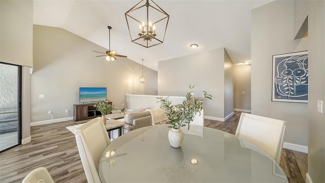 dining room with hardwood / wood-style flooring, ceiling fan, and vaulted ceiling