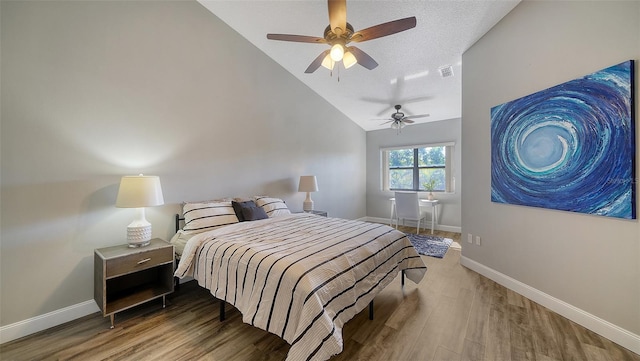 bedroom with wood-type flooring, lofted ceiling, and ceiling fan