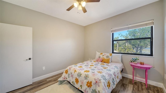 bedroom with wood-type flooring and ceiling fan