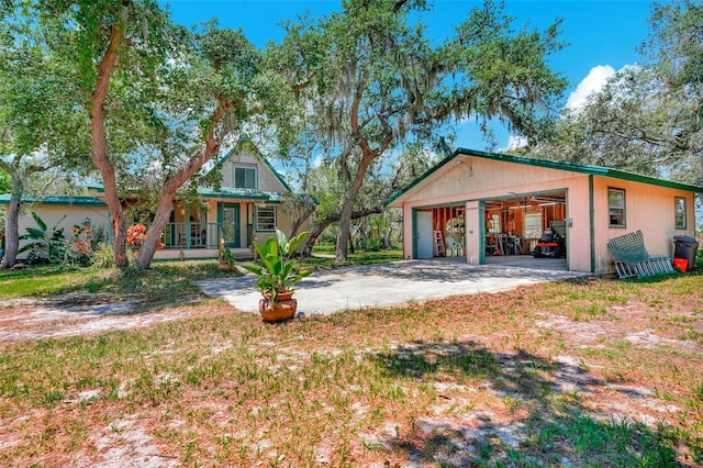 exterior space featuring an outdoor structure, a porch, and a garage