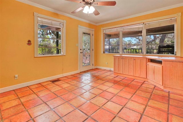 interior space with ceiling fan and ornamental molding